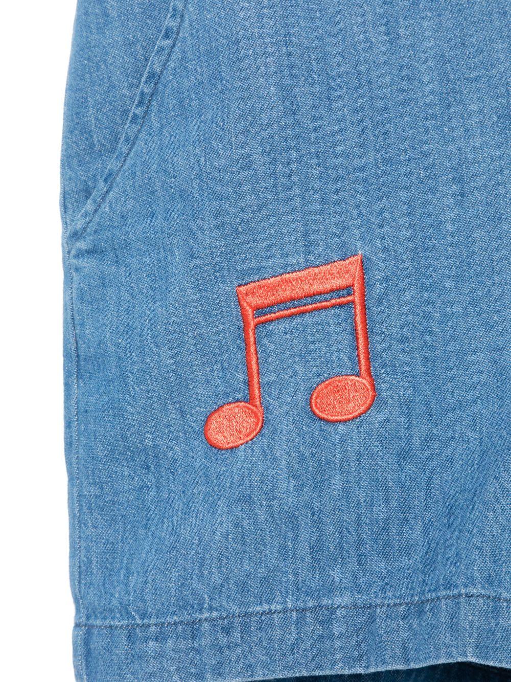 Tuta corta per bambina in denim con ricamo e due tasche diagonali laterali - Image 2